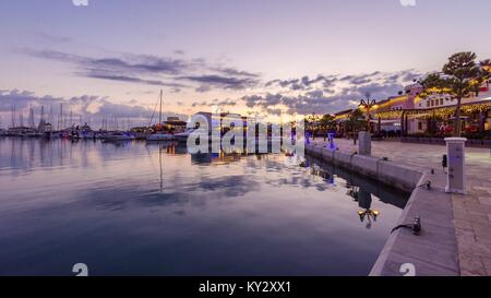 Beautiful Marina in Limassol city Cyprus at dusk. A modern, high end life and newly developed port with docked yachts, restaurants, shops, a landmark  Stock Photo