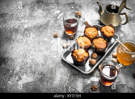 Honey muffins with fragrant tea. On a rustic background. Stock Photo