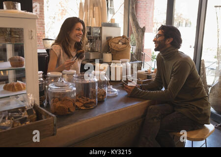Smiling waitress talking to customer Stock Photo