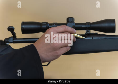 Man Loading Rifle Man loading bullet into sniper rifle Stock Photo - Alamy
