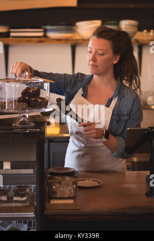 Beautiful waitress working at counter Stock Photo