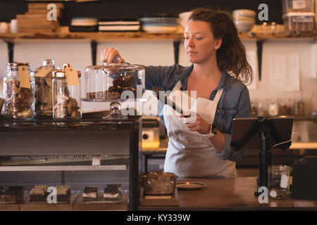 Beautiful waitress working at counter Stock Photo