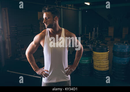 Determined muscular man standing with hands on hip Stock Photo