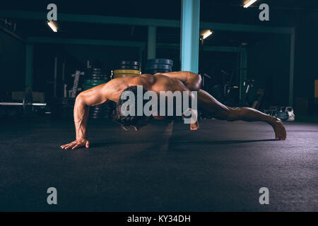 Determined muscular man doing push-up Stock Photo
