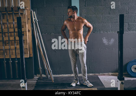 Determined muscular man standing with hands on hip Stock Photo