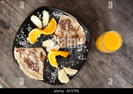 breakfast from pankakes and orange juice, vintage wooden background Stock Photo