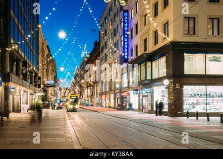 Helsinki, Finland - December 6, 2016: Tram Departs From Stop On Aleksanterinkatu Street. Street With Railroad In Kluuvi District In Evening Or Night C Stock Photo