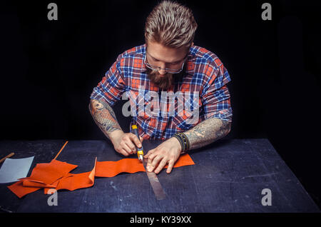 Artisan of leather manufacturing new leather product Stock Photo