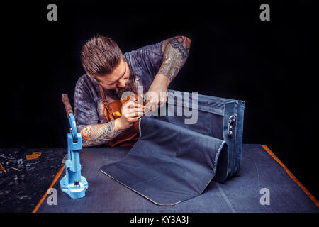Leather Artisan at work at workshop Stock Photo