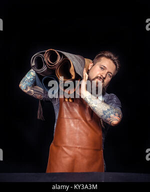 Worker of leather being keen on his buisness Stock Photo