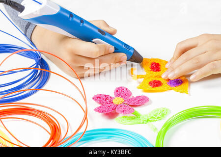 Kid hands holding 3d printing pen and making new item Stock Photo - Alamy