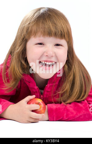 Cheerful kid holding apple and laughing isolated on white Stock Photo