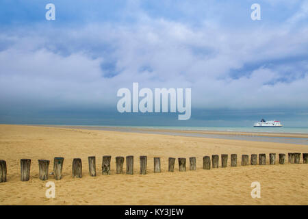 Sangatte - Bleriot Plage (northern France): posts in the sand, on the beach, and boat belonging to the shipping company P&O Stock Photo
