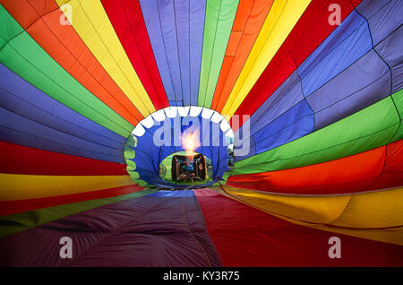 View from the inside of hot air balloon as fire heats the air the balloon rises off the ground. Stock Photo