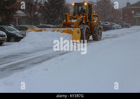 January 04 2018 NY New York: Snow-removing machine cleans the street of the city park from the snow in the morning snow-covered trees. Cleaning road f Stock Photo