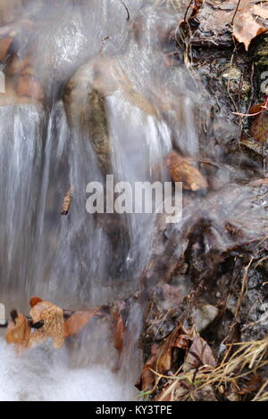 Small waterfall on a warm spring day Stock Photo