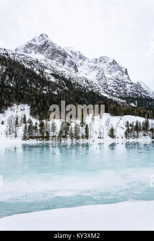 The frozen lake Ferchensee near Mittenwald with snowy mountains and cloudy sky Stock Photo