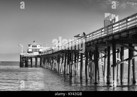 Malibu, California, USA - July 4,2011: Fishing on a wooden pier in Malibu at sunset. Stock Photo