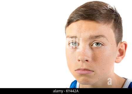 Teenage boy headshot looking sad agaisnt a white background Stock Photo