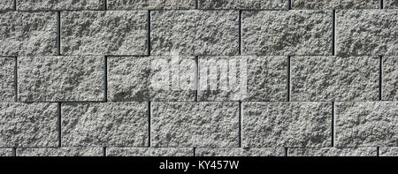 Gray wall from stone bricks. Beautiful wide-angle texture from concrete blocks. Stock Photo