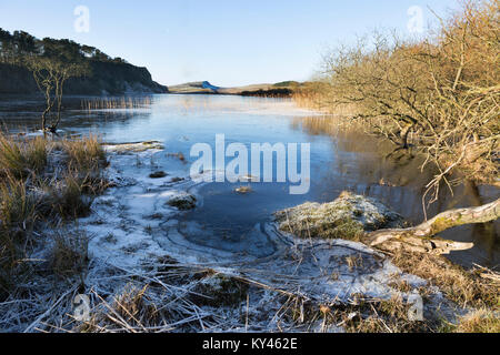 Hadrian's Wall: Crag Lough, frozen, in the grip of winter, on a beautiful sunny day. The view looking west towards Steel Rigg and Winshield Crags. Stock Photo