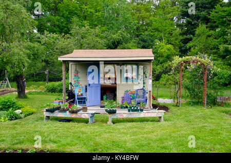 Potting shed with seedlings. Painted shed in Community Garden, Maine, USA Stock Photo