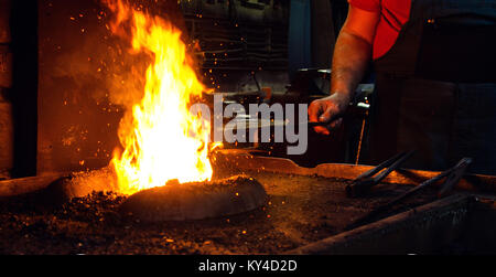 Blacksmith at work, hit with a hammer by a hot metal on the anvil. Stock Photo