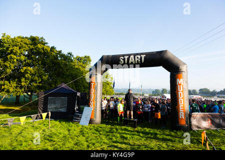 Sussex, UK. A large group of competitors listens to a pre-event announcement before they begin the Tough Mudder obstacle course. Stock Photo