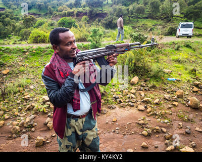 SEMIEN MOUNTAINS, ETHIOPIA - JULY 01, 2016: A man holding  a kalashnikov in Semien mountains, Ehtiopia. Stock Photo