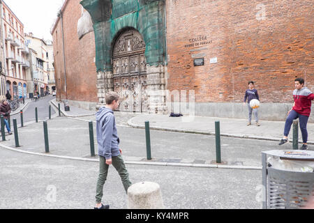 Local,boys,playing,football,near,Place du Capitole,Toulouse,French,department, of, Haute-Garonne, region of, Occitanie, France,French,Europe,European, Stock Photo