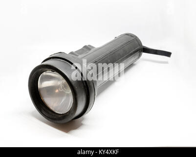 A black rubber torch or flashlight isolated on a white background. Stock Photo