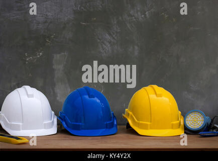 safety helmet on old cement texture  background and copy space for construction concept Stock Photo