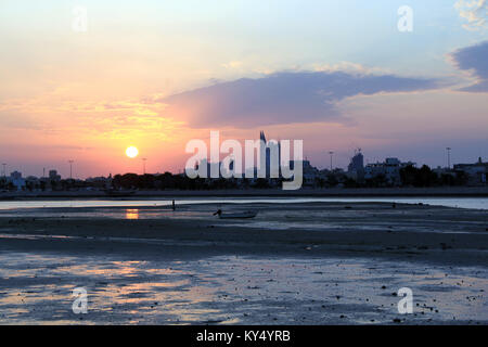 Sunset and gulf with boat in Manama city, Bahrein Stock Photo