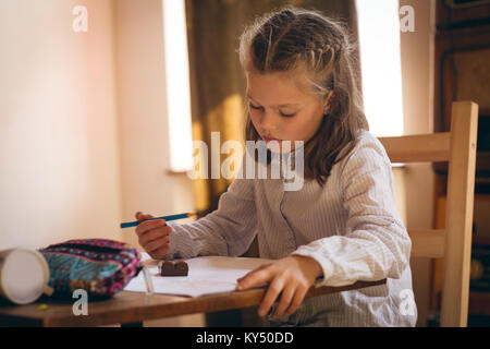 Girl doing her homework at home Stock Photo