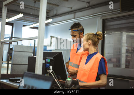Two workers discussing with each other Stock Photo