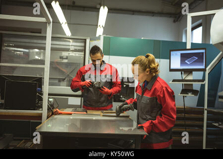Two workers operating a scanning machine Stock Photo