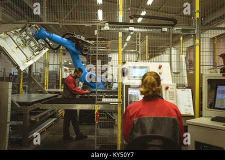 Female worker operating machine Stock Photo
