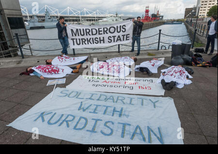 Kurds stage a 'die-in' wearing bloodstained white sheets opposite the DSEi Arms Fair. They protest against Turkish arms sales and sales of arms to Turkey which it uses in rhe massacres of Kurds. Stock Photo