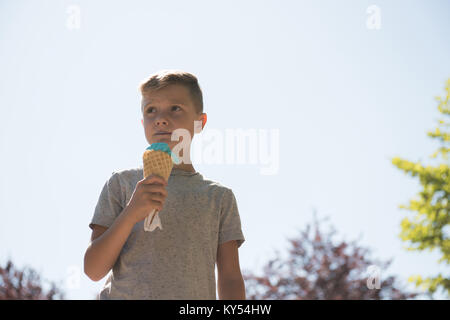 Thoughtful boy having ice cream Stock Photo