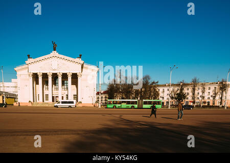 Gomel, Belarus - March 27, 2016: City transport and people walking on Lenin Square near Gomel Drama Theatre Stock Photo