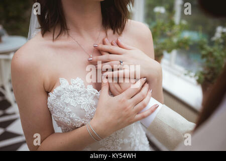 Groom placing his hand on brides chest Stock Photo