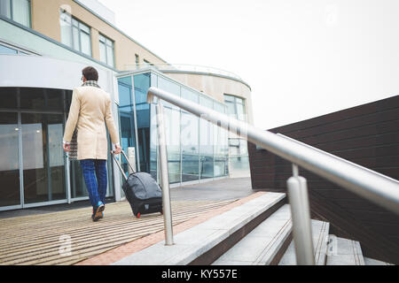 Businessman arriving in hotel on a sunny day Stock Photo