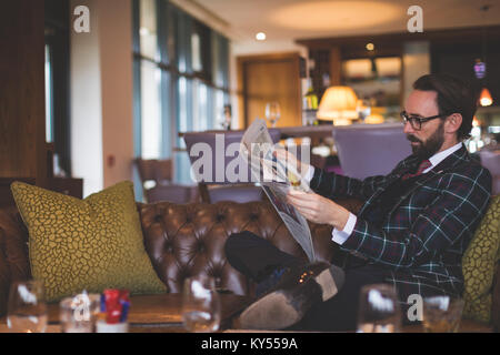 Businessman reading newspaper Stock Photo