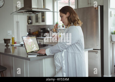 Pregnant woman working on laptop Stock Photo