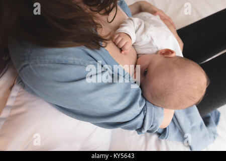Nude mother breastfeeding infant son Stock Photo - Alamy