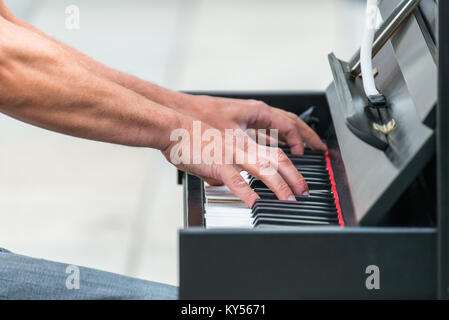 Street musician playing the piano Stock Photo