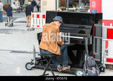 Regensburg, Bavaria, Germany, August 22, 2017: Street musician playing the piano Stock Photo