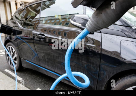 Electric car at public charging point in central London, UK Stock Photo