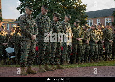 U.S. Marine Corps Maj. Gen. John K. Love, commanding general, 2nd Marine Division (2d MARDIV), left, Sgt. Maj. Michael P. Woods, sergeant major, 2d MARDIV, Senior Chief Petty Officer Jill Bankus bow their heads for the invocation during a morning colors award ceremony on Camp Lejeune, N.C., Dec. 12, 2017. The ceremony is held to honor colors as well as award Marines and Sailors. (U.S. Marine Corps Stock Photo