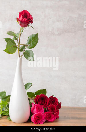 red rose in white vase and marble background Stock Photo